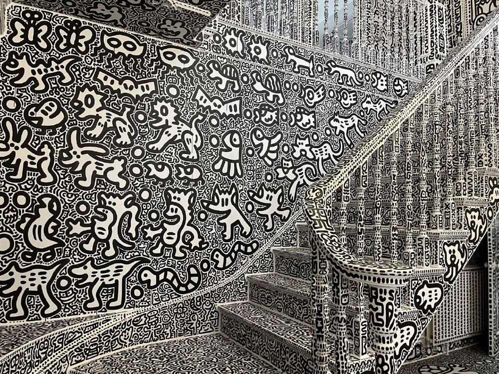 a staircase and wall covered in doodles