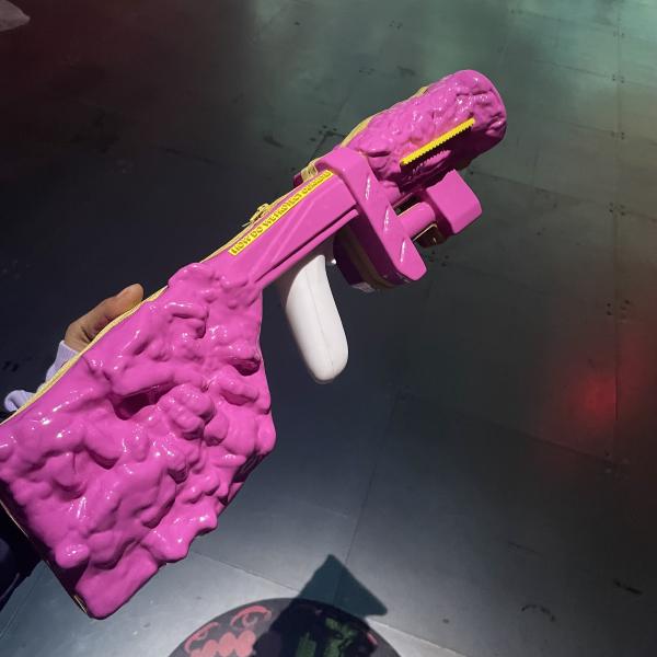 my hand (ZM) holding a chunky bubblegum pink plastic gun
