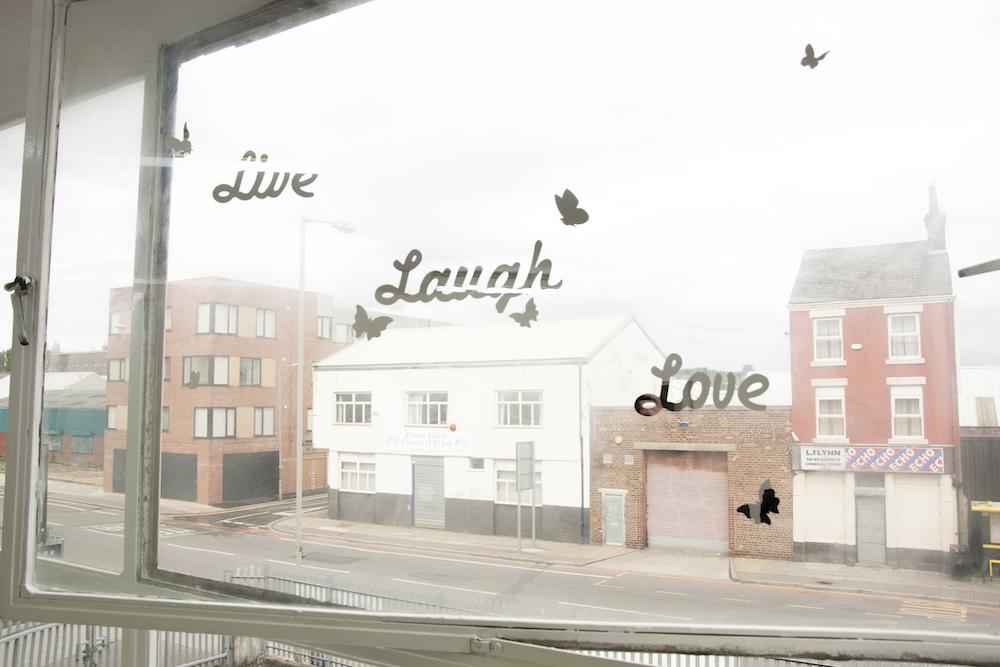 a live laugh love decal surrounded by butterflies on the gallery window