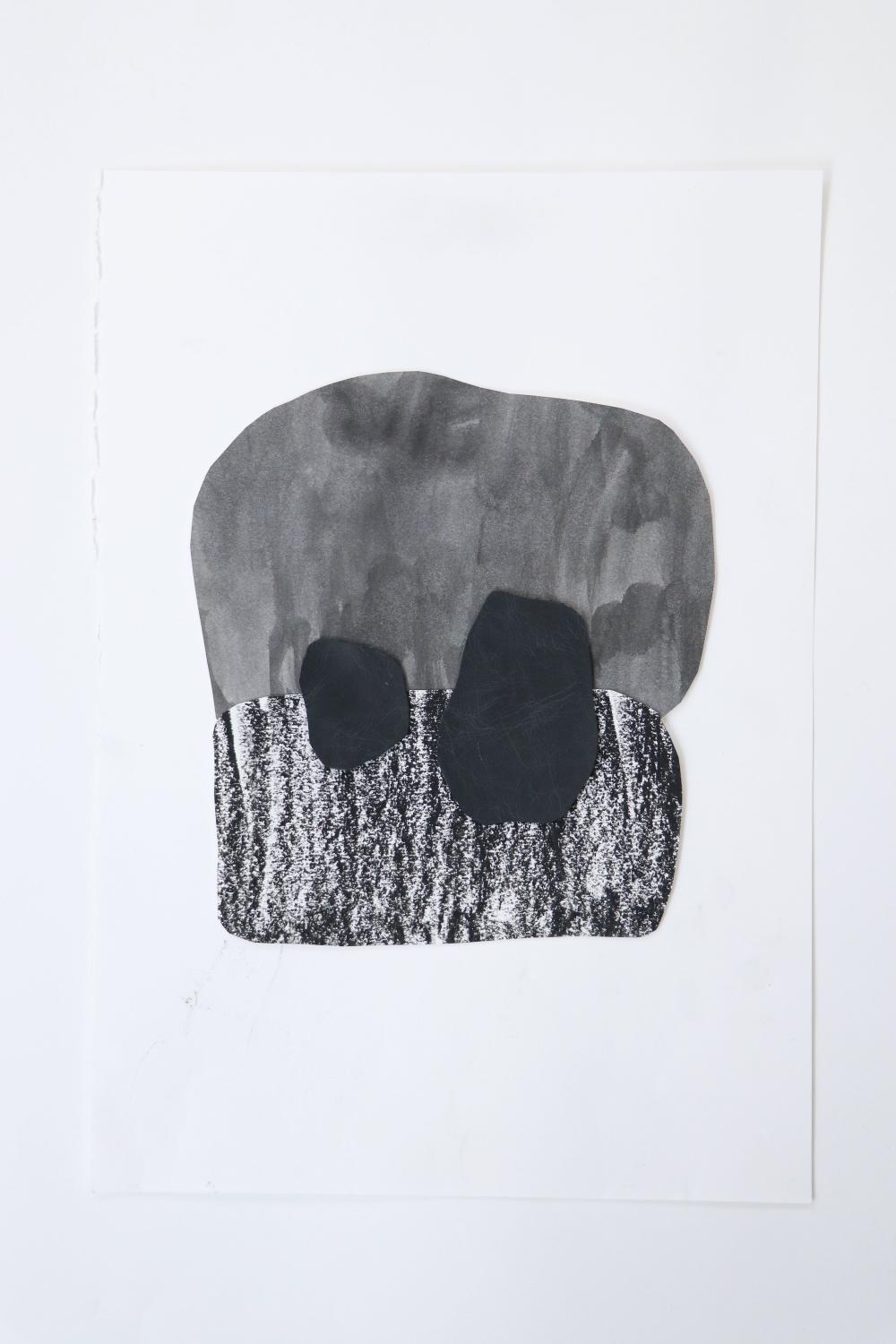 a black and white artwork with a washed out watercolur blob above a crayony scratchy blob, with two darker rock-shapes with these upper and lower shapes overlap