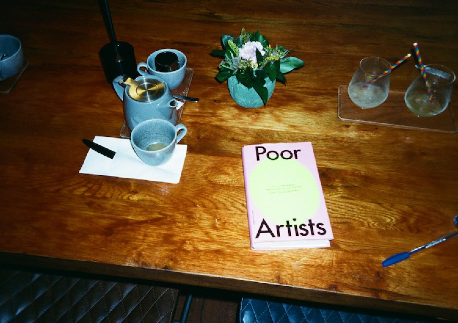 poor artists book on a table in a cafe