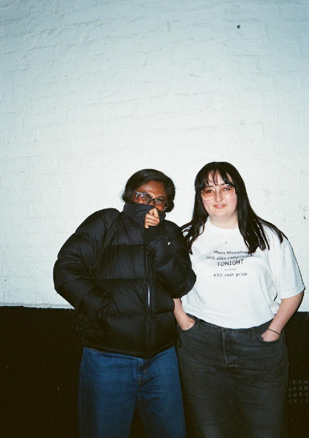 gab and zarina smiling against a white wall