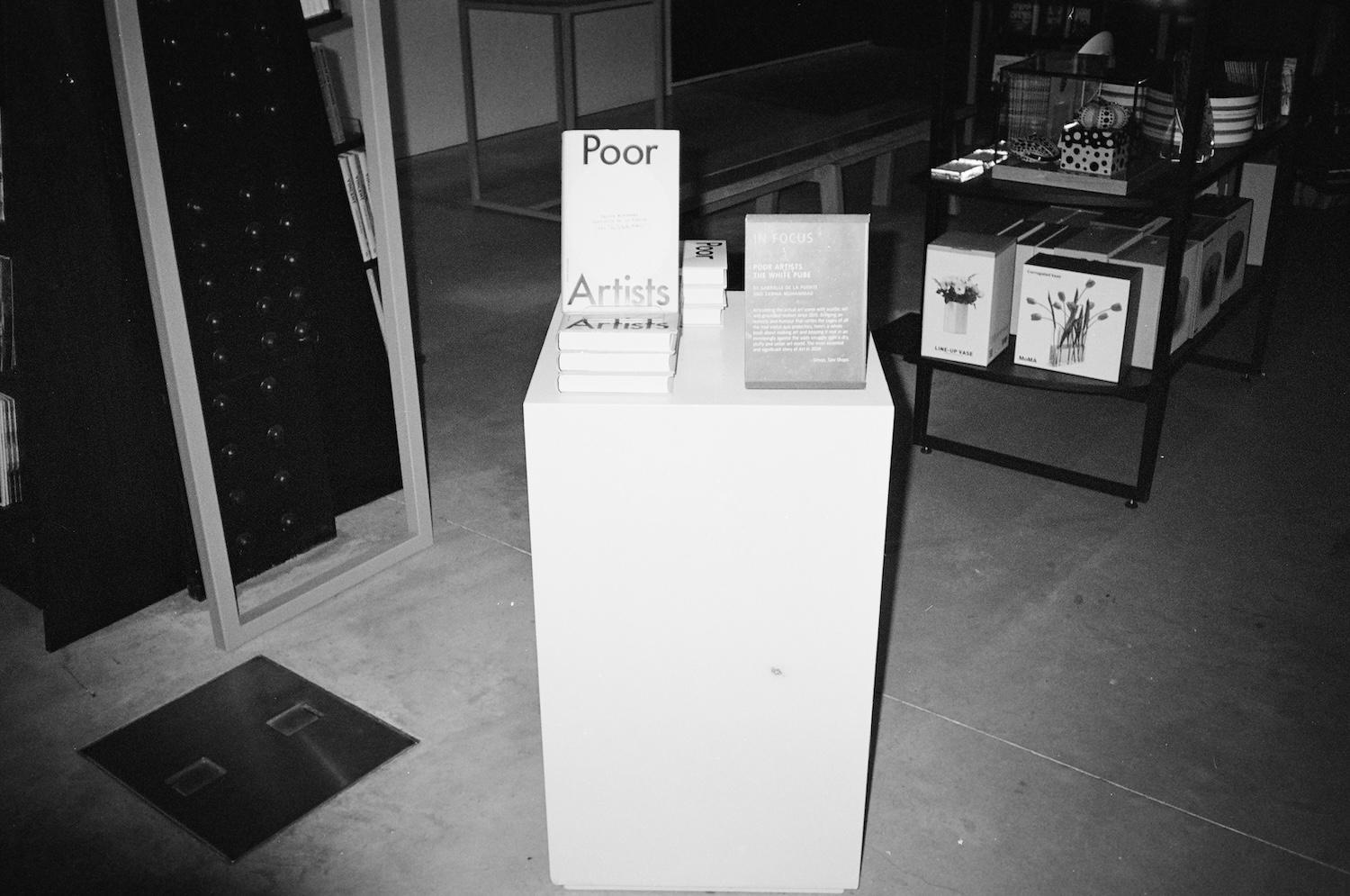 a stack of poor artists books on a plinth