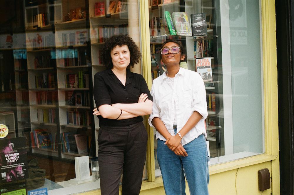Zarina and Polly Barton smiling outside of Dead Ink on smithdown road