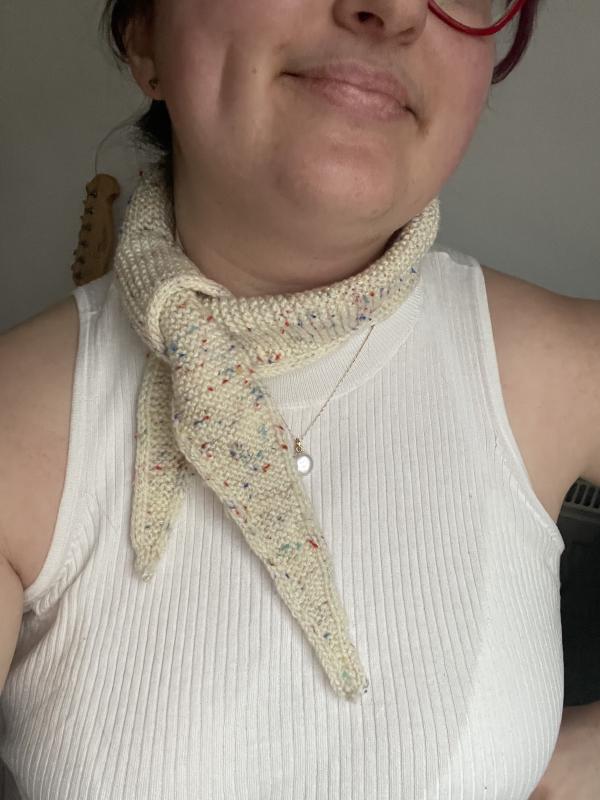 a beige knitted neckerchief