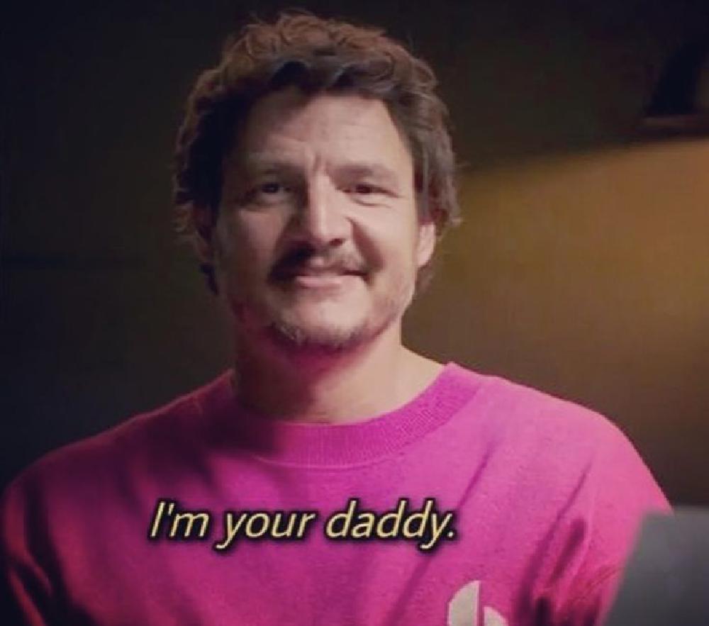 pedro saying im your daddy to the camera in a bright pink sweater