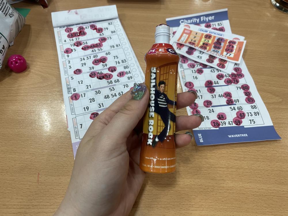 jailhouse rock elvis bingo dabber gab's holding beside some stamped bingo tickets