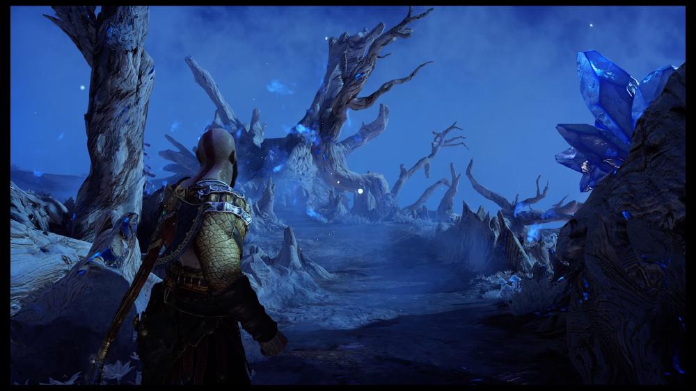 Kratos walks through a blue purple portal world that takes him between places, where the land is made up of twisted branches and glowing dark blue stones