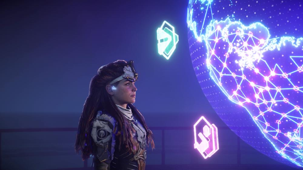 Aloy looks at a holographic illustration of the globe made up of blue and purple lights in the air