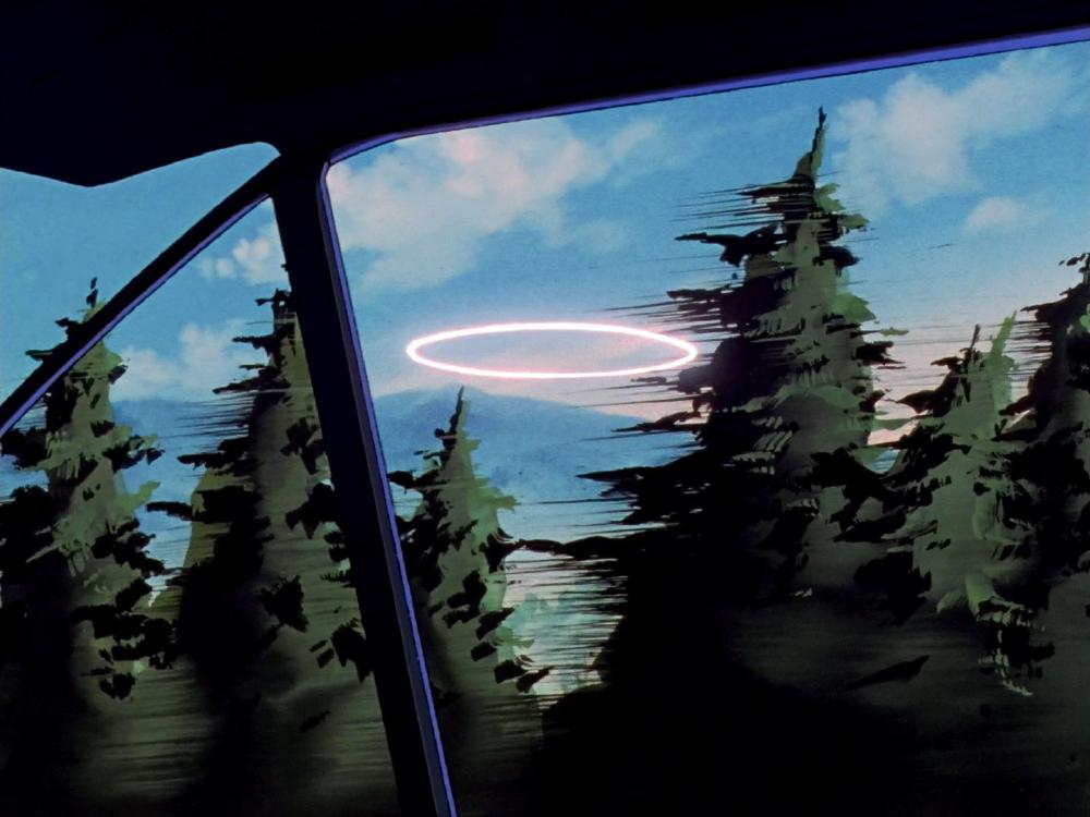 a bright halo is floating in the sky between fir trees, viewed in motion from a car so there are lines coming off of the trees to indicate movement