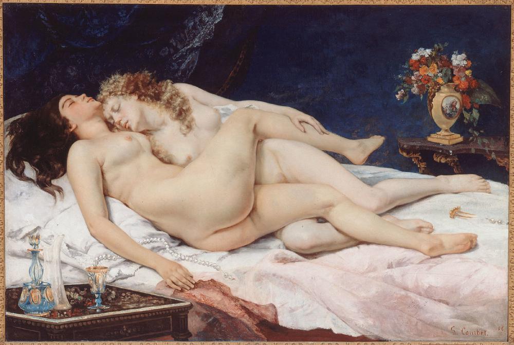 a lesbian couple with legs intwined, naked on a bed