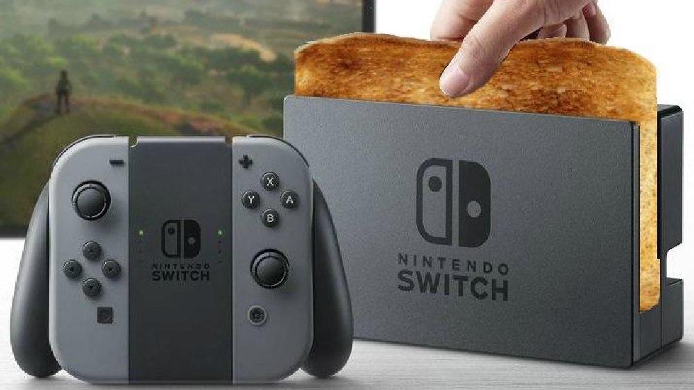 someone has edited a nintendo switch dock so that it has a piece of bread in it instead of the switch, like a toaster