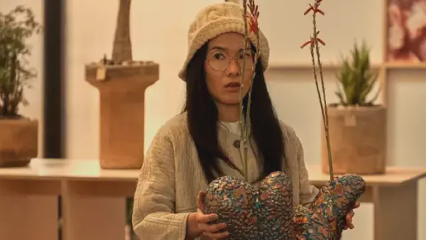 ali wong in a beige cable knit bucket hat that is folded up at the front