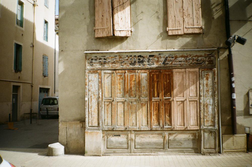 an old wooden shop front with its shutters closed in Millau