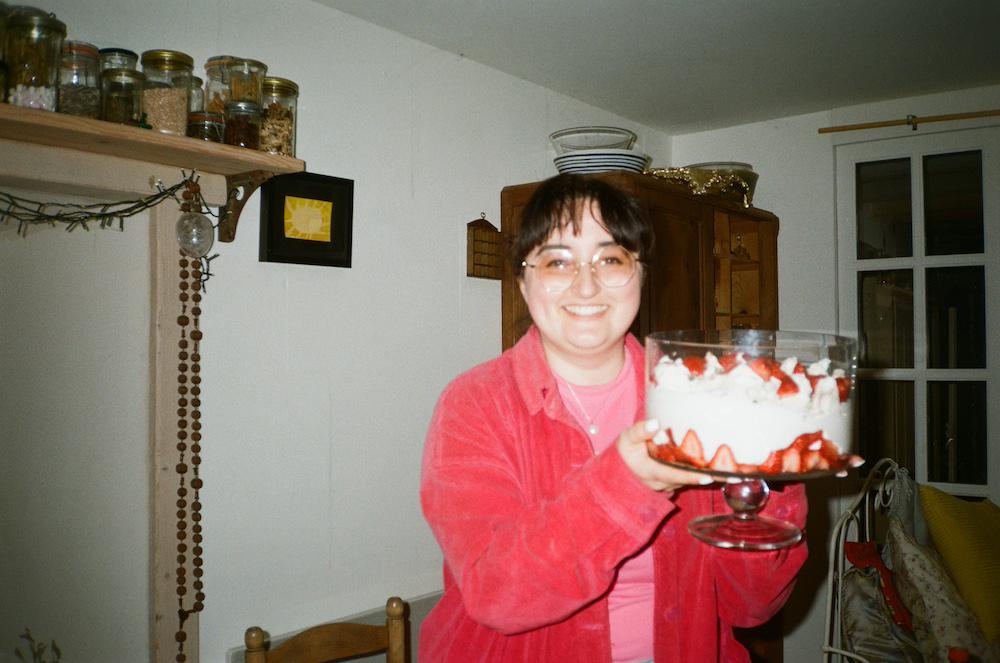Me holding a big beautiful eton mess i made and smiling
