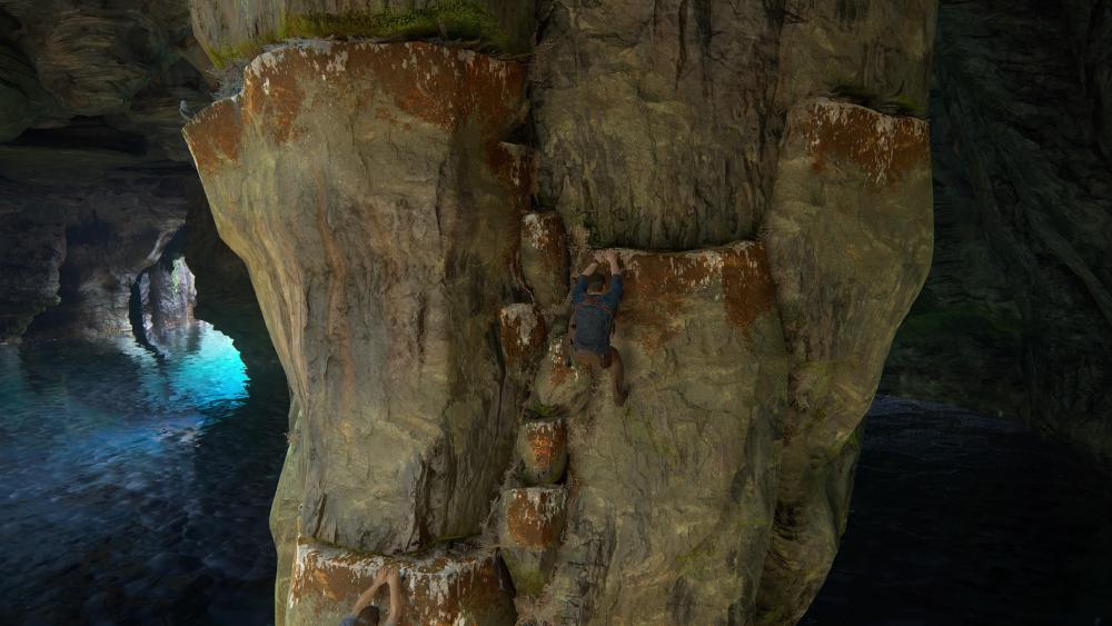 Nathan is climbing yet again, this time on a big rocky column at the centre of a watery cave, which just so happens to have white marks on small ledges that make footholds and handholds in a path up and around the column