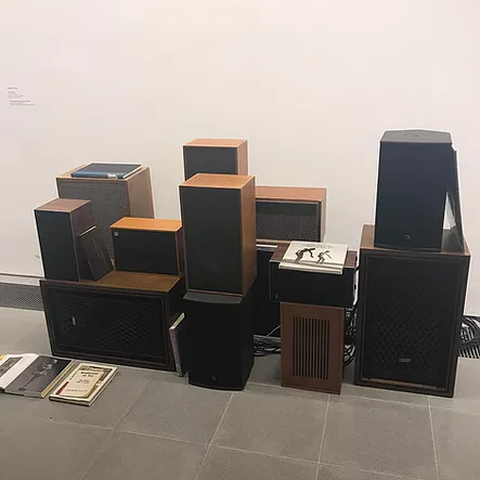 a collections of speakers are stacked in a pile