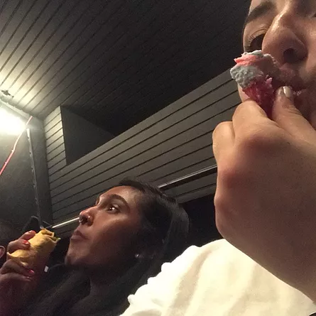 a sneaky selfie of Gabrielle and Zarina at the back of the auditorium eating some snacks while they listen