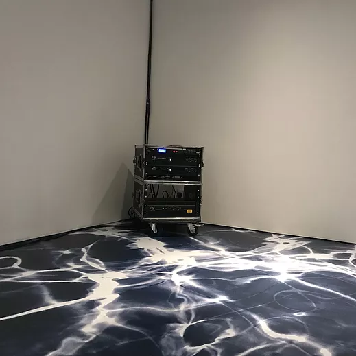 the floor of the gallery looks like something between tie dye and wave patterns, and the corner of the gallery has a little metal cabinet with sound mixing gear on it