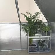 an upside down metal shelving unit on the floor is holding plants on top of it