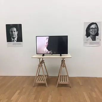 two headshots of people while a tv screen in the middle of them plays a video
