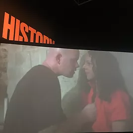 a bald man comes close to a woman