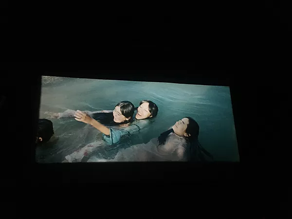 three girls float in water having fun