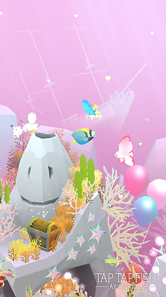 a close up of more fish in the aquarium shows a pink butterfly fish, balloons, and a treasure chest