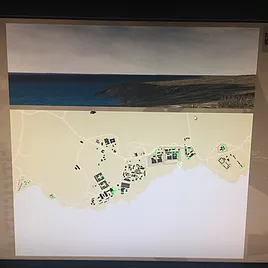 the edge of a map is seen above an image of the coast