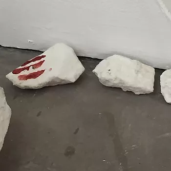 white chunks on the floor, and one has red lines across it like finger prints almost
