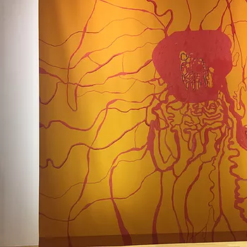 a huge orange painting with a darker orange scrawling pattern over it like veins or a big blood clot