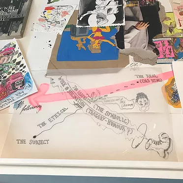 the drawings in the vitrine include a loose abstract line going from the the subject to the real, with a boot, a face, a pink arrow, and in the background there are more drawings on top of one another including a simpsons character in a bikini