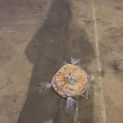 some flatbreads in plastic wrappers on the floor