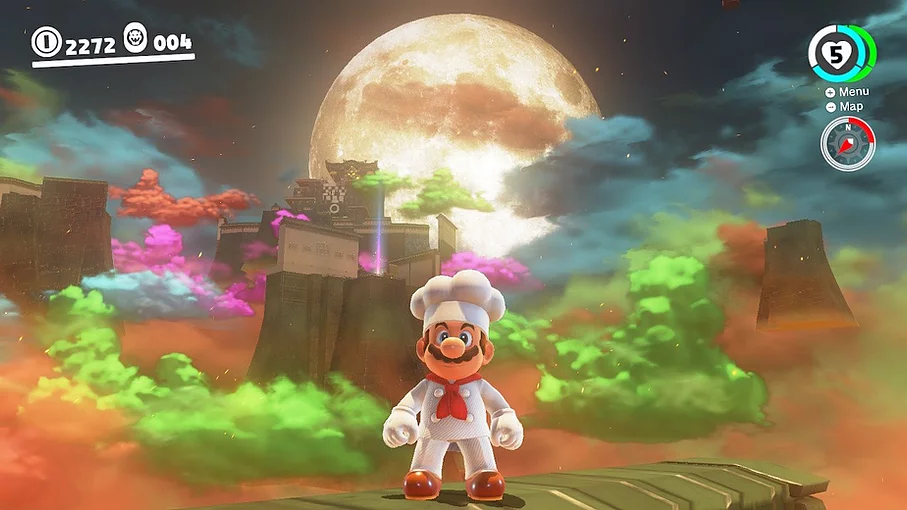 Mario is wearing a chef's outfit and behind him, there is a bizarre landscape of colourful clouds and temples with a moon filling the rest of the space