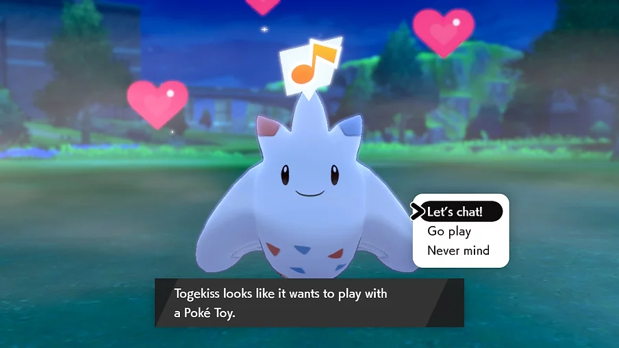 Togekiss is looking directly at the camera saying it wants to play with a poke toy