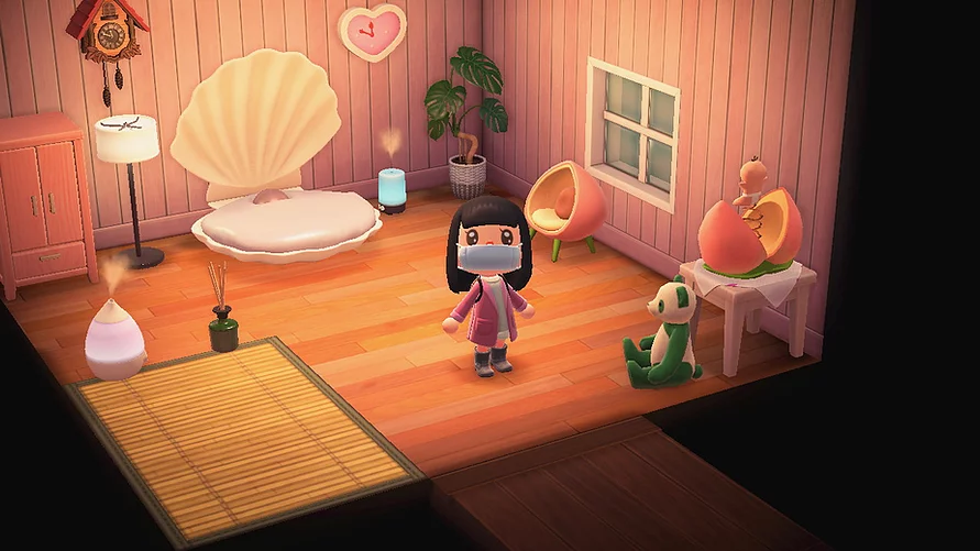 a shot inside Gab&rsquo;s bedroom in animal crossing where there is a big pink shell bed, a bamboo mat, an incense burner, a chair styled like a big peach, and a green and white panda