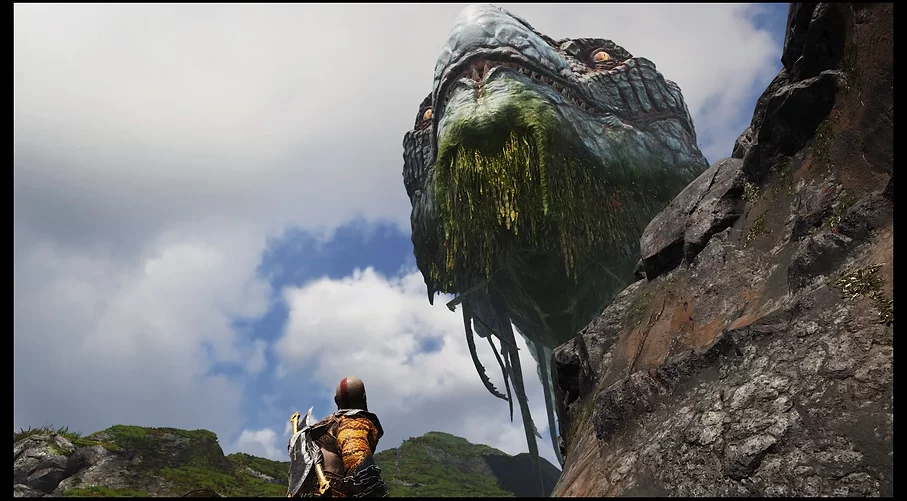 the world serpent looks down from the sky at Kratos who is tiny in comparison. The head of the snake has golden eyes, and its chin is dripping with seaweed-like growths