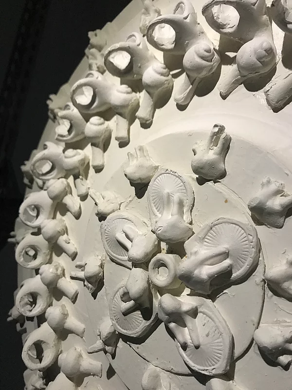 a ceiling rose with repeated patterns of abstract shapes