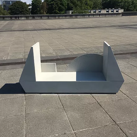 a cement bench with two raised triangles at the side of it