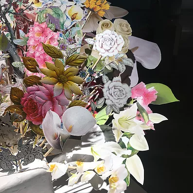 a close up of the paper bouquet, and it looks like the flowers have been taken from greeting cards and cut out