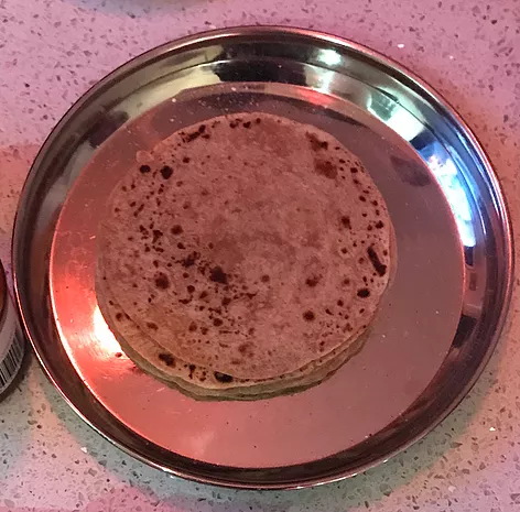 a stack of rotli on a metal reflective plate