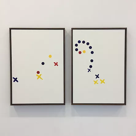 odd circles and crosses in primary colours on two white paintings