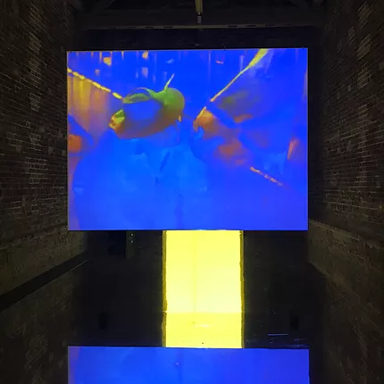 a projection of blue and yellow and i cant tell what it is showing