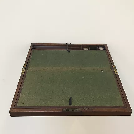 a writing box, dark green centre with mahogany frame