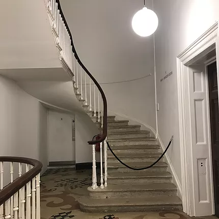staircase with a rope across the bottom for no entry