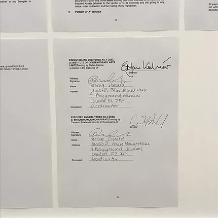pieces of paper stuck on the wall with signed contracts and addresses handwritten