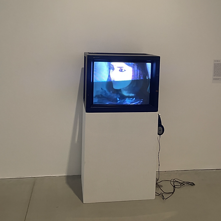 a CRT tv on a plinth shows a woman&rsquo;s face