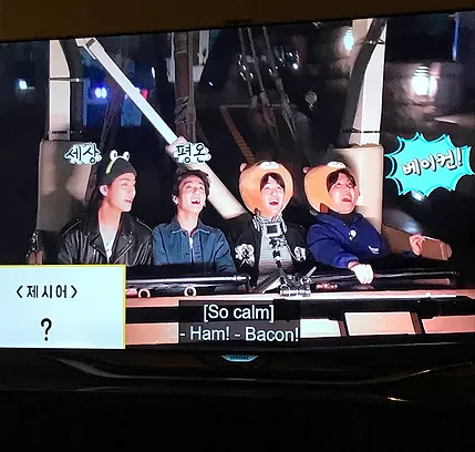 two BTS boys are sat next to another two who are wearing the bear hats from before, and the caption says HAM, BACON