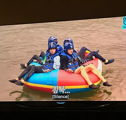 the group are in a dingy on a brown river