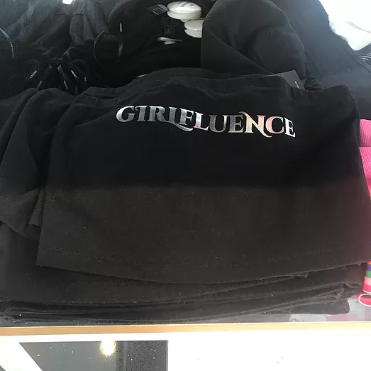 another black tshirt but the silver text on top says girlfluence
